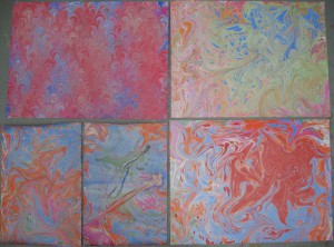Two more marbled 12×18″ handmade sheets, and three 18×24″ sheets of commercially-made paper. Lily did the marbling for all of these except the upper-left one.