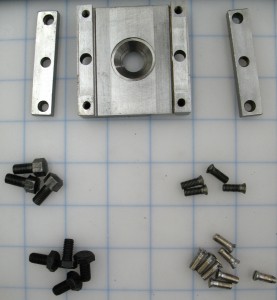 One of the sliding blocks disassembled. Some of the screws and bolts were missing. The upper groups are originals, and the lower groups are replacements.