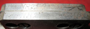 The part and serial numbers (1½ NR2F903H #114). The 1½ is probably the width in points and the 'F' might mean full-face rule. Other moulds had a number instead of the 'F'.